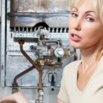 A woman assessing a metallic boiler and pipes, representing home appliance maintenance by The Meridian Company.