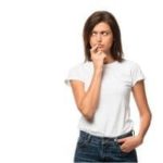 Contemplative woman in a white t-shirt, representing introspection in home services by The Meridian Company.