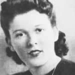 Black and white portrait of a woman with vintage hairstyle, showcasing classic expertise by The Meridian Company.