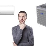 Man considering home comfort options with split and window air conditioning units - Meridian Company's HVAC advice.