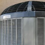 Air conditioning unit with metal construction, installed outdoors, highlighting HVAC solutions by The Meridian Company.